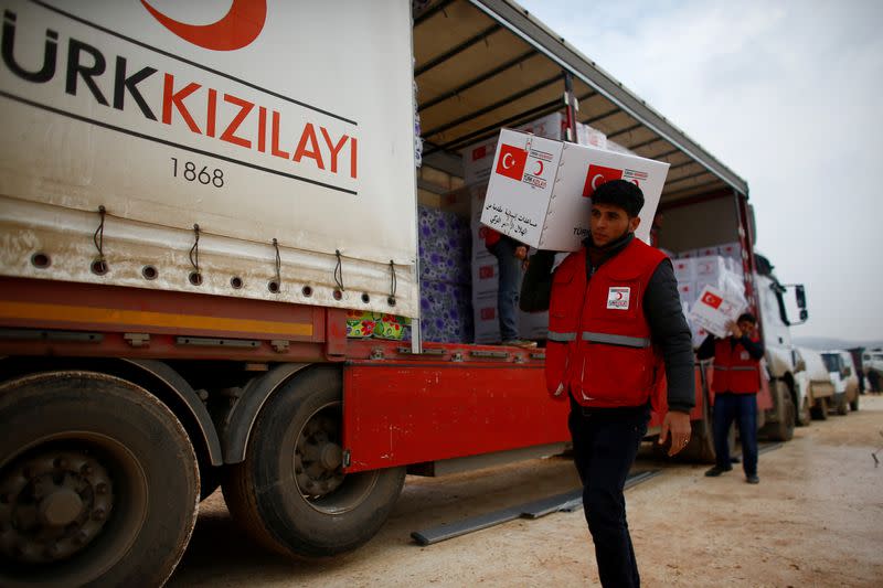 FILE PHOTO: Turkish Red Crescent workers carry humanitarian aid at Kelbit camp in Idlib province