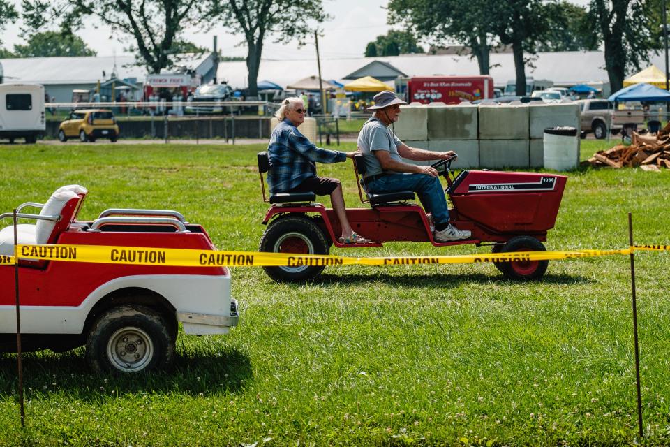 People traverse the annual Tuscarawas Valley Pioneer Power show, Friday Aug. 18 at the Tuscarawas County Fairgrounds in Dover. The event, which happens yearly, is also known as the Dover Steam Show.