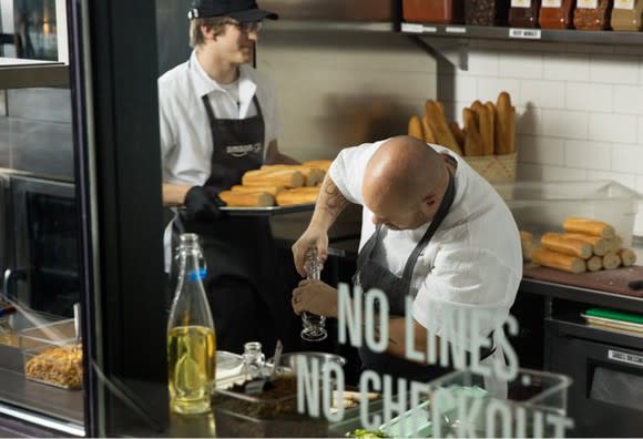 Cooks prepare food inside an Amazon Go store