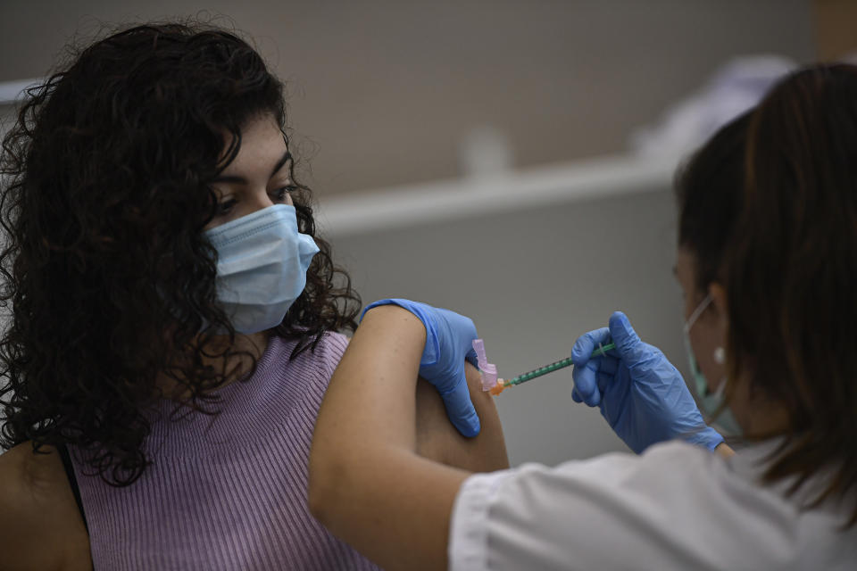 A woman receives the Pfizer COVID-19 vaccine during the national COVID-19 vaccination campaign in Pamplona, northern Spain, Thursday, Sept. 2, 2021. Spanish authorities say more than seventy percent of citizens have been vaccinated. (AP Photo/Alvaro Barrientos)
