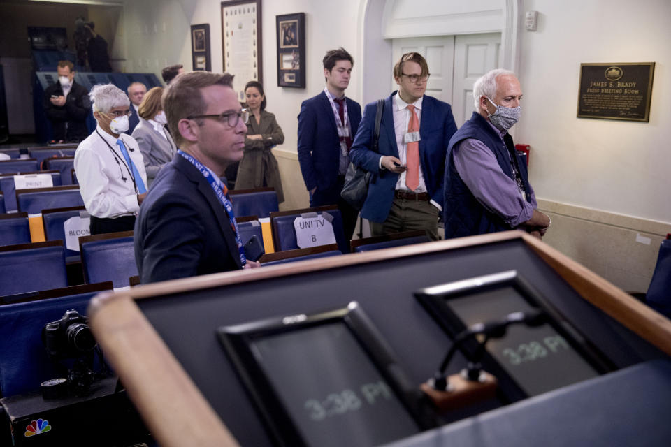 Members of the media wait in line to receive a test for COVID-19 by the White House Medical Unit before attending a news conference with President Donald Trump in the press briefing room at the White House, Thursday, April 9, 2020, in Washington. (AP Photo/Andrew Harnik)
