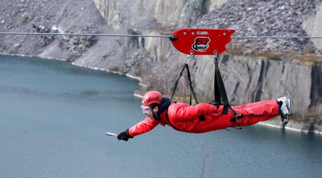 A man (name not given) goes down the zip wire at Zip World in Penrhyn Quarry, Bethesda, Bangor, North Wales. (PA Archive)