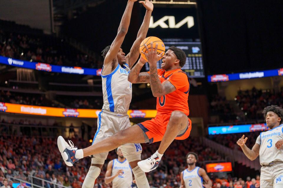 Auburn guard K.D. Johnson (0) goes to the basket as Memphis' Keonte Kennedy defends during the first half of an NCAA college basketball game Saturday, Dec. 10, 2022, in Atlanta. (AP Photo/Erik Rank)