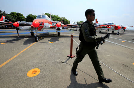 A soldier walk pass two of the three units of Beechcraft TC90 aircraft from the Japan Ministry of Defense (JMOD) during a transfer ceremony of the aircrafts to the Philippine Navy at the Naval Air Group (NAG) headquarters in Sangley Point, Cavite city, Philippines March 26, 2018. REUTERS/Romeo Ranoco