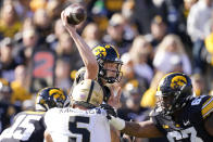 Iowa quarterback Spencer Petras, center, throws a pass during the first half of an NCAA college football game against Purdue, Saturday, Oct. 16, 2021, in Iowa City, Iowa. Purdue won 24-7. (AP Photo/Charlie Neibergall)