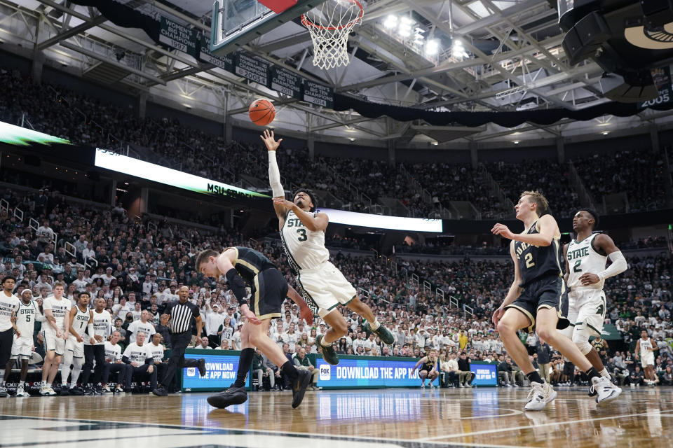 Michigan State guard Jaden Akins (3) makes next to Purdue guard Braden Smith during the second half of an NCAA college basketball game, Monday, Jan. 16, 2023, in East Lansing, Mich. (AP Photo/Carlos Osorio)