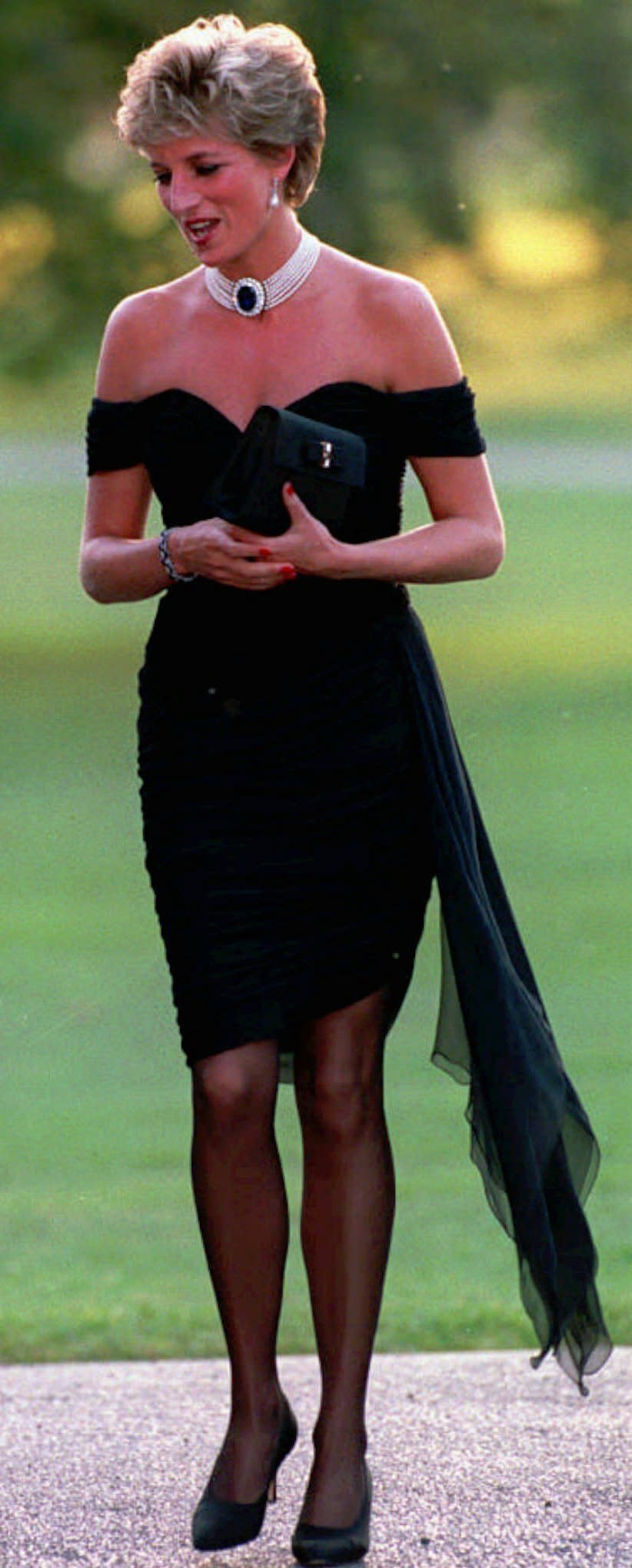 FILE - Diana, Princess of Wales wearing a black pleated chiffon dress, with floating side panel, by Christina Stamboulian, during a party given at the Serpentine Gallery in London in 1996. Above all, there was shock. That’s the word people use over and over again when they remember Princess Diana’s death in a Paris car crash 25 years ago this week. The woman the world watched grow from a shy teenage nursery school teacher into a glamorous celebrity who comforted AIDS patients and campaigned for landmine removal couldn’t be dead at the age of 36, could she? (AP Photo, PA, File)