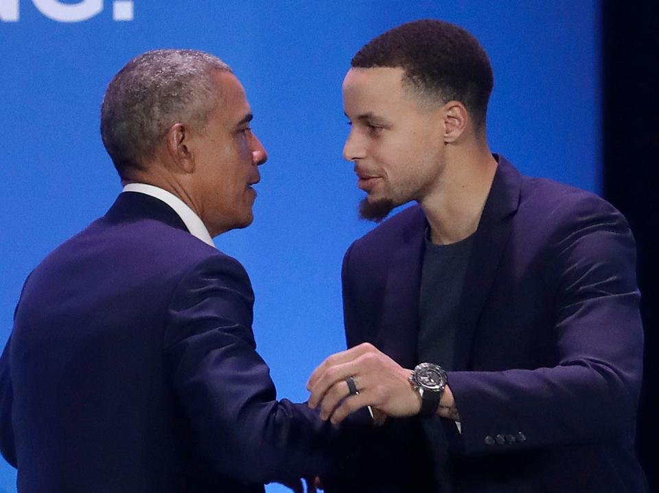 Barack Obama and Stephen Curry lean in to hug at an event in 2019.