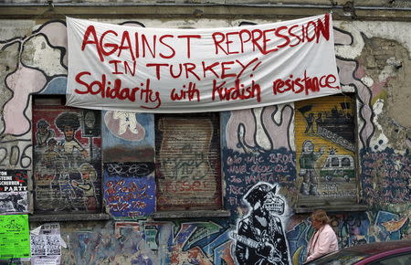 A banner hangs on a squatter house in Berlin, Germany, April 13, 2016. REUTERS/Hannibal Hanschke