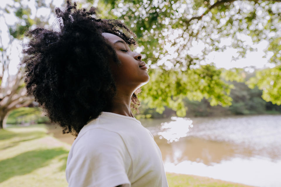 A child breathing clean air in nature