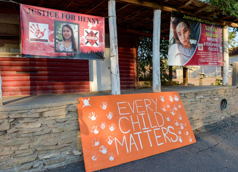 Signs hang in Lame Deer, Montana, for Henny Scott, 14, who was found dead in 2018, and Kaysera Stops Pretty Places, 18, who was found dead near a busy street in nearby Hardin in 2019.