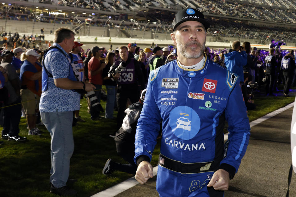 Jimmie Johnson walks down pit road before the first of two Daytona 500 qualifying auto races at Daytona International Speedway, Thursday, Feb. 15, 2024, in Daytona Beach, Fla. (AP Photo/Terry Renna)