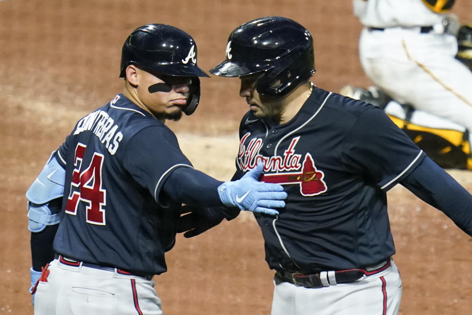 Atlanta Braves' Travis d'Arnaud, right, is greeted by William Contreras (24) after hitting a solo home run against the Pittsburgh Pirates during the fifth inning of a baseball game, Tuesday, Aug. 23, 2022, in Pittsburgh. (AP Photo/Keith Srakocic)