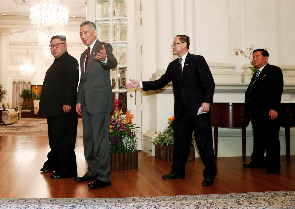 <p>President Donald Trump is met by Singapore’s Foreign Minister Vivian Balakrishnan and other officials after arriving in Singapore June 10, 2018. (Photo: Ministry of Communications and Information, Singapore via Reuters) </p>