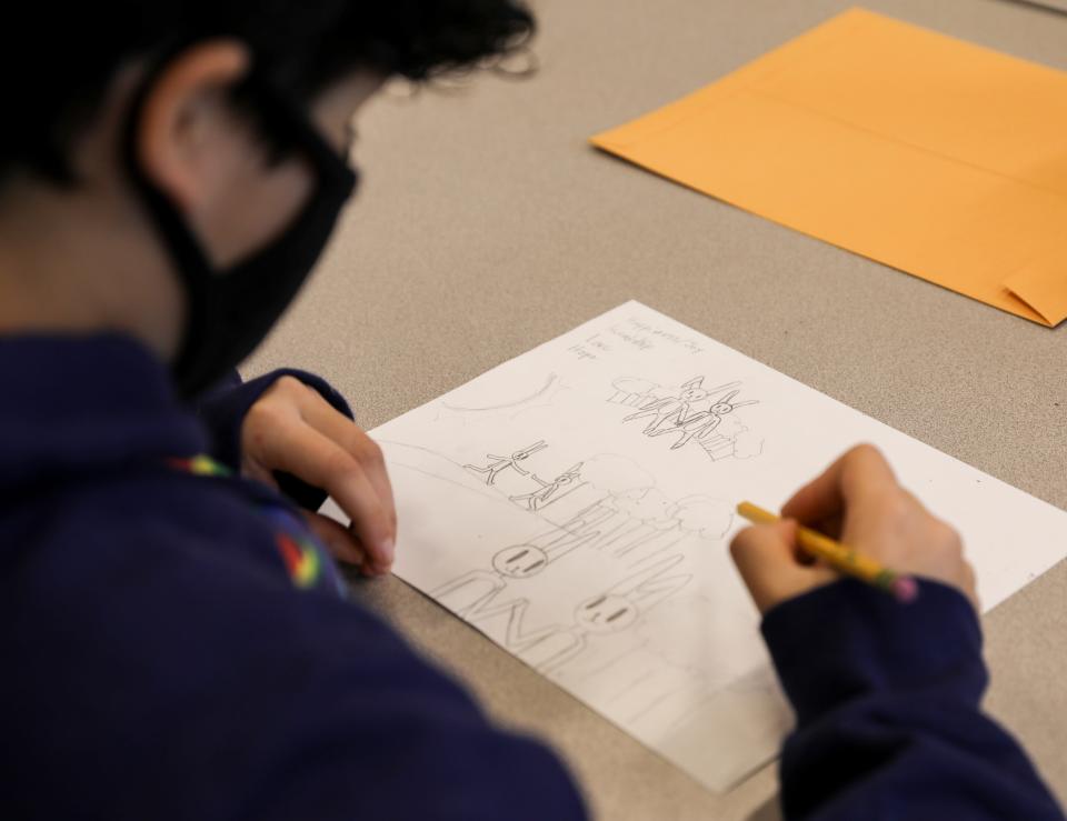 Seventh-grader Tyler Astorga draws thumbnails based around the ideas of love, hope, friendship and joy on Wednesday at Howard Street Charter School.