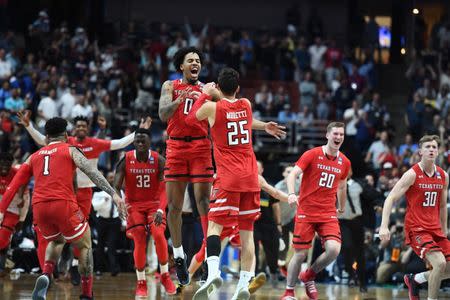 March 30, 2019; Anaheim, CA, USA; Texas Tech Red Raiders guard Kyler Edwards (0) guard Davide Moretti (25) and the bench celebrate the victory over Gonzaga Bulldogs in the championship game of the west regional of the 2019 NCAA Tournament at Honda Center. Mandatory Credit: Robert Hanashiro-USA TODAY Sports