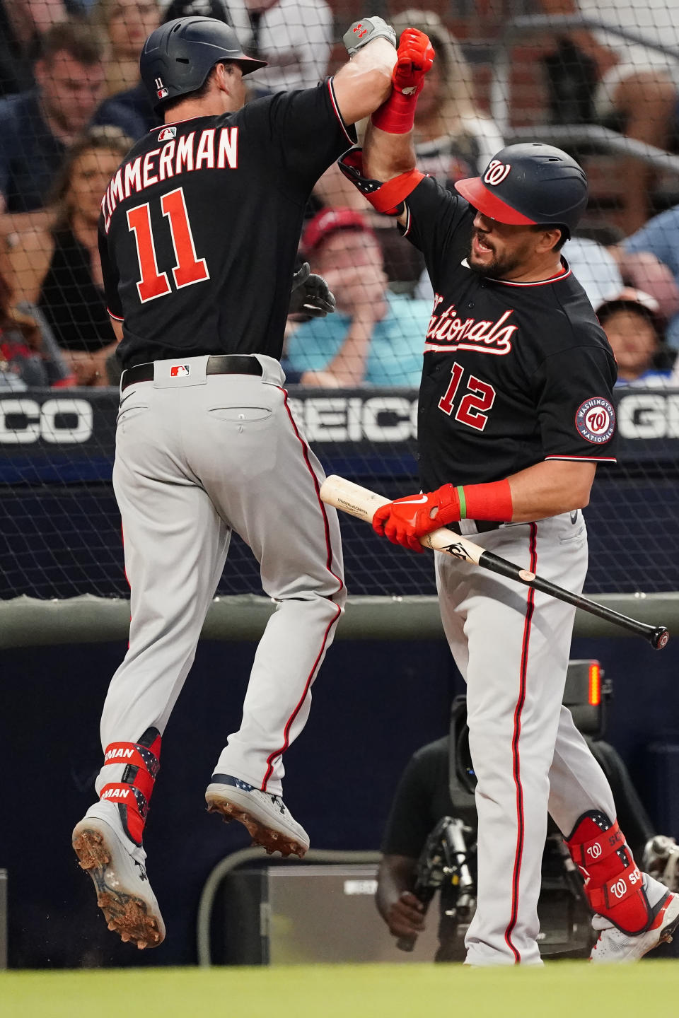 Washington Nationals' Ryan Zimmerman (11) celebrates with Kyle Schwarber (12) after hitting a two-run home run in the fourth inning of a baseball game against the Atlanta Braves Tuesday, June 1, 2021, in Atlanta. (AP Photo/John Bazemore)