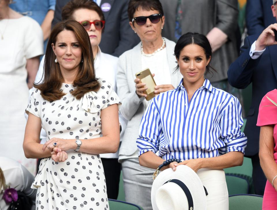 Catherine, Duchess of Cambridge and Meghan, Duchess of Sussex attend day twelve of the Wimbledon Tennis Championships at the All England Lawn Tennis and Croquet Club on July 14, 2018