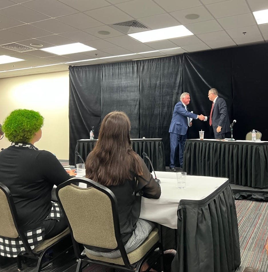 Democratic incumbent Rep. David Trone, at left, shakes hands with his Republican opponent for the Congressional District Six state Del. Neil Parrott, at right, after a candidate forum at Frostburg State University on Oct. 24, 2022.