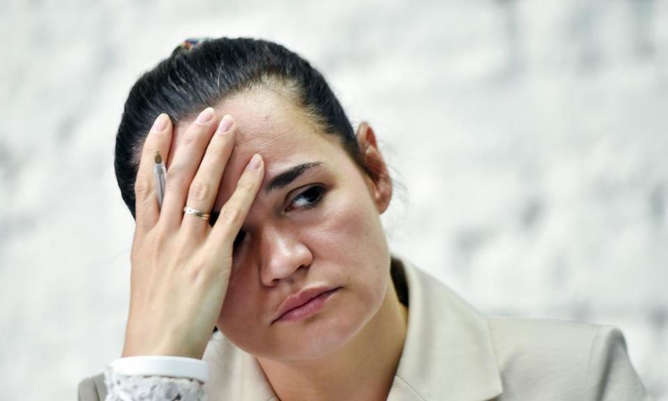 Svetlana Tikhanovskaya resting her head on one hand at a press conference