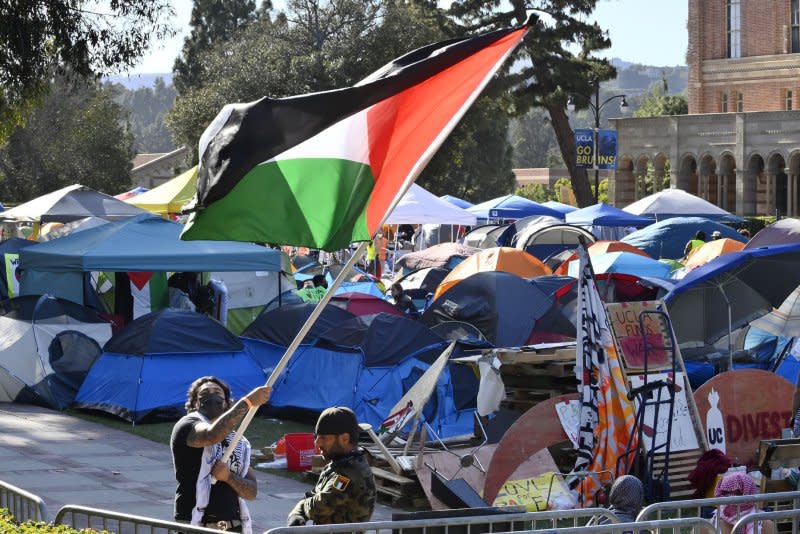 A pro-Palestinian encampment is seen cordoned off Sunday by stanchions on the UCLA campus. Things turned violent over the weekend when pro-Israeli activists held a rally of their own in proximity of the encampment. Mary Osako, vice chancellor of UCLA Strategic Communications, issued a statement Sunday saying, "We are heartbroken to report that today, some physical altercations broke out among demonstrators on Royce Quad." Photo by Jim Ruymen/UPI