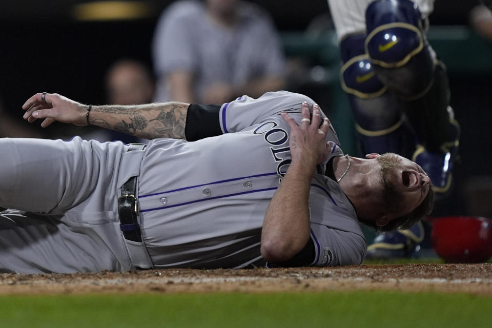 Colorado Rockies' Kyle Freeland reacts after being tagged out at home plate by Philadelphia Phillies pitcher Jeff Hoffman during the ninth inning of a baseball game, Monday, April 15, 2024, in Philadelphia. Rockies left-hander Kyle Freeland appeared to injure his right, non-throwing shoulder while being used as a pinch-runner in the ninth inning of Monday night's game against the Phillies. (AP Photo/Matt Rourke)