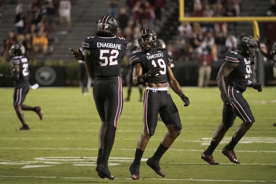 South Carolina linebacker Brad Johnson (19) and defensive lineman Kingsley Enagbare (52) celebrate a stop against Tennessee during the first half of an NCAA college football game Saturday, Sept. 26, 2020, in Columbia, S.C. (AP Photo/Sean Rayford)