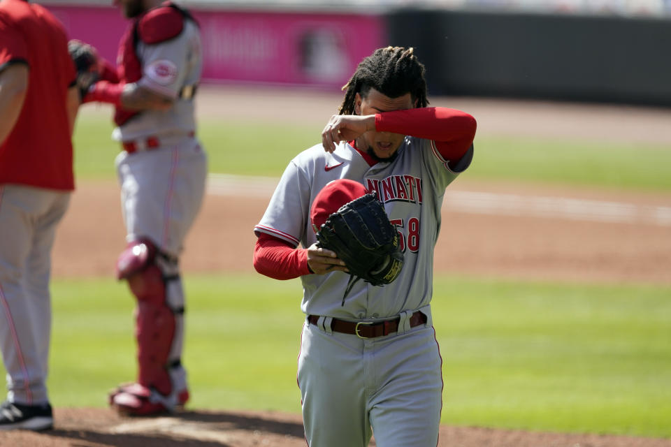 Cincinnati Reds starting pitcher Luis Castillo heads to the dugout after he was relieved during the sixth inning against the Atlanta Braves in Game 2 of a National League wild-card baseball series, Thursday, Oct. 1, 2020, in Atlanta. (AP Photo/John Bazemore)