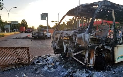 View of vehicles burnt during protests on the eve in Santa Elena de Uairen, Venezuela -in the border with Brazil - Credit: AFP