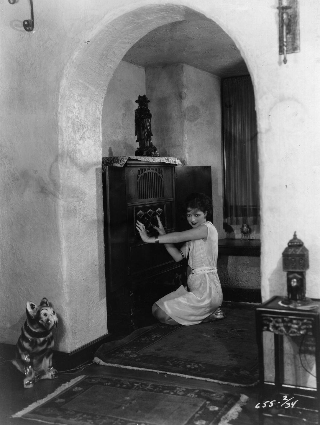 circa 1930 american silent film star and it girl clara bow with her wireless set in the hall of her hollywood home photo by margaret chutegetty images