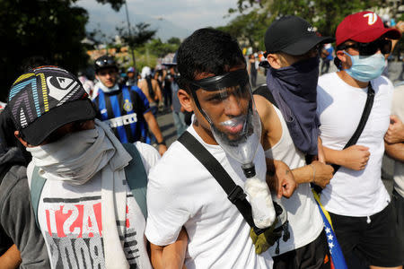 A demonstrator uses a home made gas mask during clashes with riot police while rallying against Venezuela's President Nicolas Maduro in Caracas, Venezuela April 24, 2017. REUTERS/Carlos Garcia Rawlins