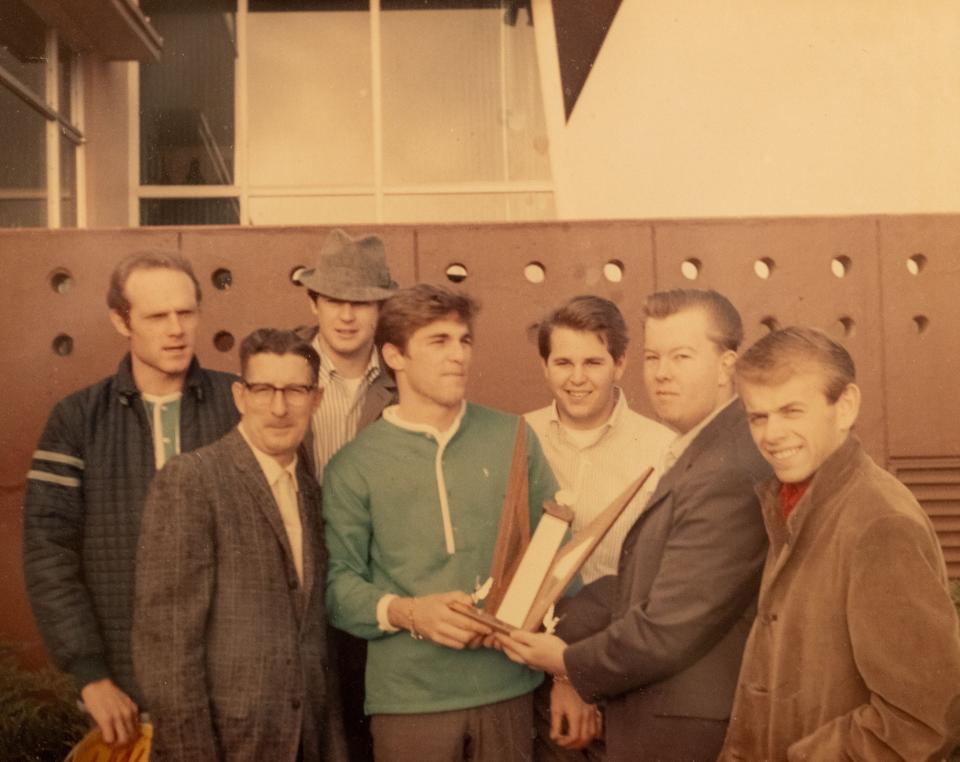 In 1963, a young Fred Vail stands with The Beach Boys. Brian Wilson stands in the back with a hat.