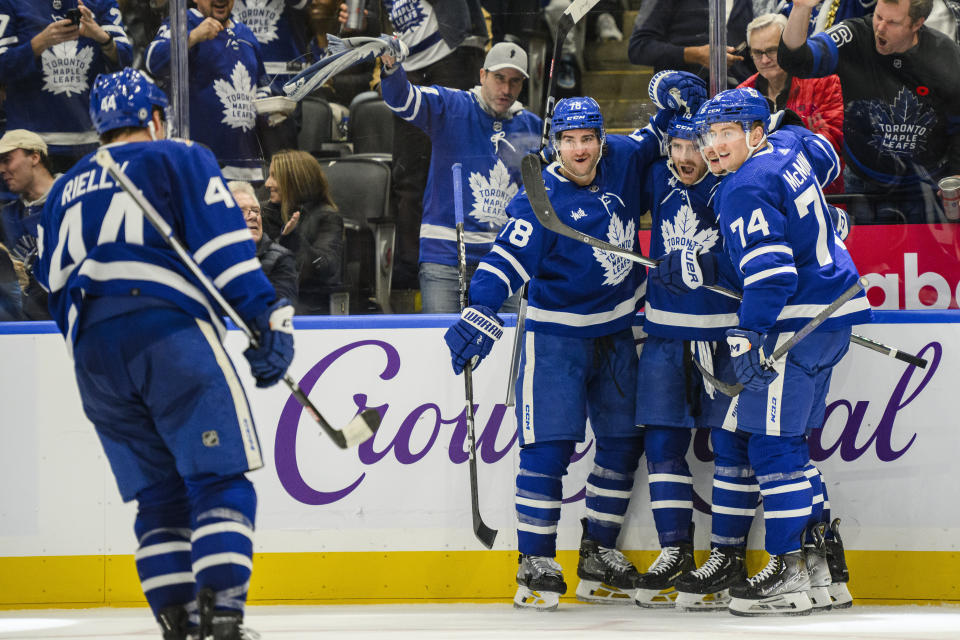 Toronto Maple Leafs centre Noah Gregor (18) celebrates with teammates after scoring during the second period of an NHL hockey match against the Vancouver Canucks in Toronto on Saturday, Nov. 11, 2023. (Christopher Katsarov/The Canadian Press via AP)