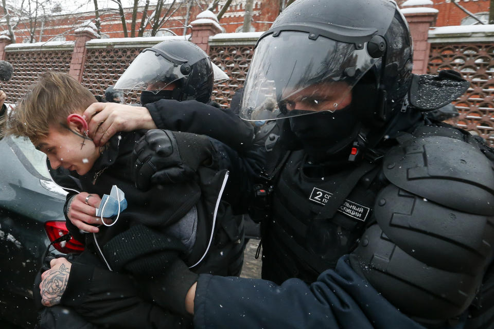 Police officers detain a young demonstrator during a protest near the Matrosskaya Tishina prison where Alexei Navalny is being held, in Moscow, Russia, on Sunday, Jan. 31, 2021. Chanting slogans against President Vladimir Putin, thousands of people took to the streets Sunday across Russia's vast expanse to demand the release of jailed opposition leader Alexei Navalny, keeping up the nationwide protests that have rattled the Kremlin. Over 1,600 were detained by police, according to a monitoring group. (AP Photo/Alexander Zemlianichenko)