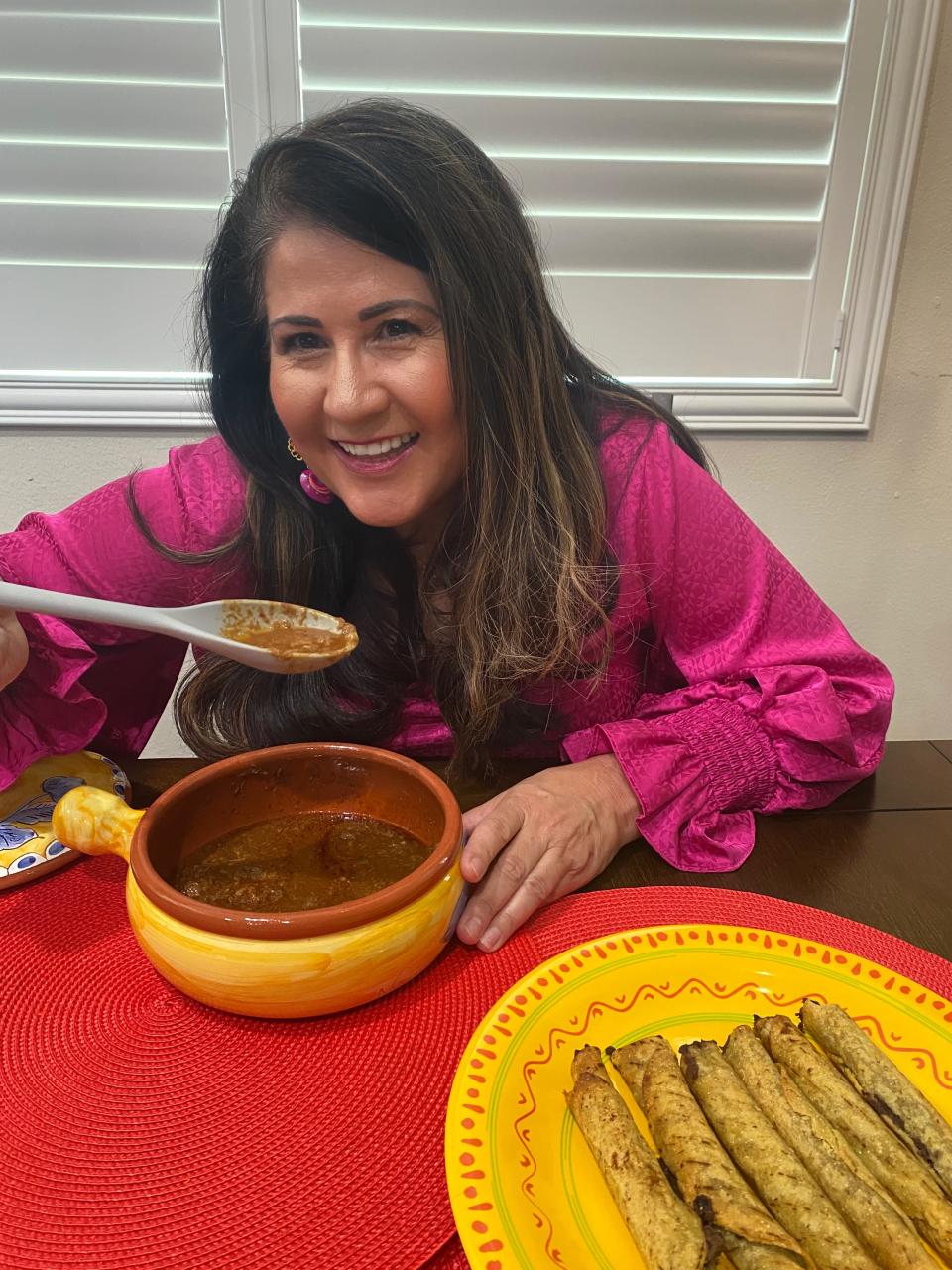 Melissa's mama trying birria from a traditional Mexican pot.