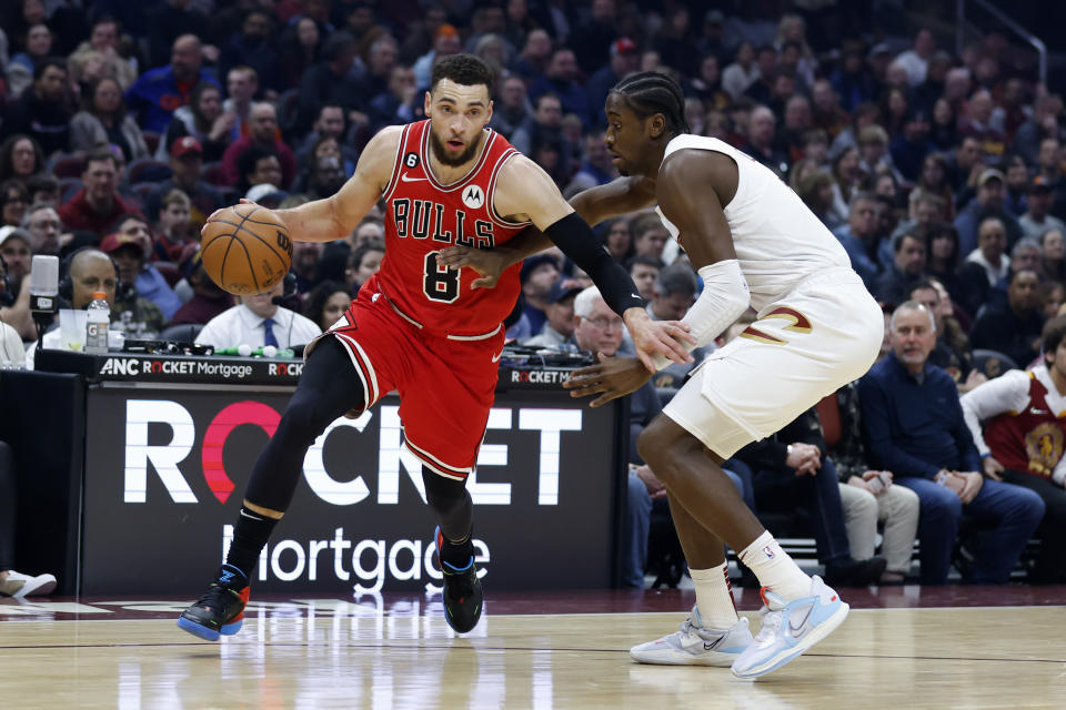 Chicago Bulls guard Zach LaVine (8) drives against Cleveland Cavaliers guard Caris LeVert during the first half of an NBA basketball game, Saturday, Feb. 11, 2023, in Cleveland. (AP Photo/Ron Schwane)