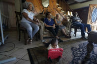 Kole Jones, great grandson of Lydia Gerard, left, a member of Concerned Citizens of St. John the Baptist Parish, plays with a toy as she and fellow residents speak to The Associated Press in Reserve, La., near the Denka Performance Elastomer Plant on Thursday, Sept. 15, 2022. The investigation of the plant is part of a push by the Biden administration to prioritize environmental enforcement in communities overburdened by pollution. (AP Photo/Gerald Herbert)