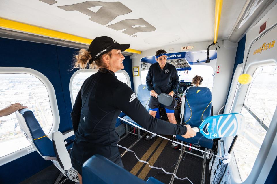 Catherine Parenteau and Jay Devilliers engage in pickleball volleys on a makeshift court aboard the Goodyear Blimp.