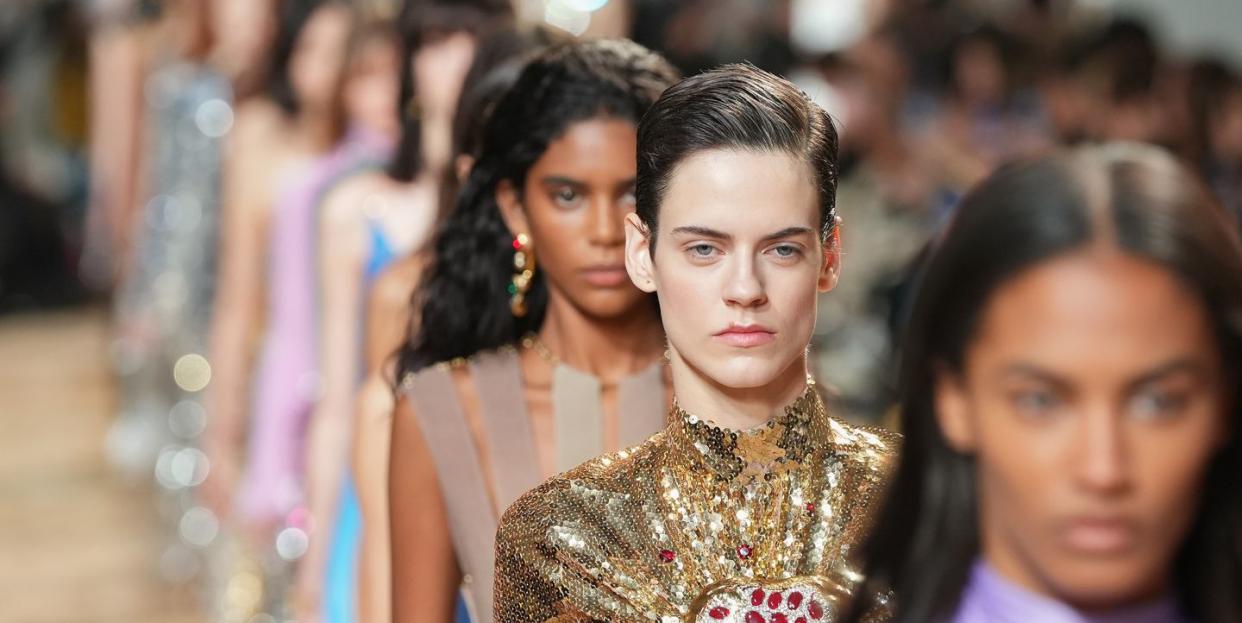 a model wearing a high neck gold dress at paco rabanne's fall 2023 show in paris
