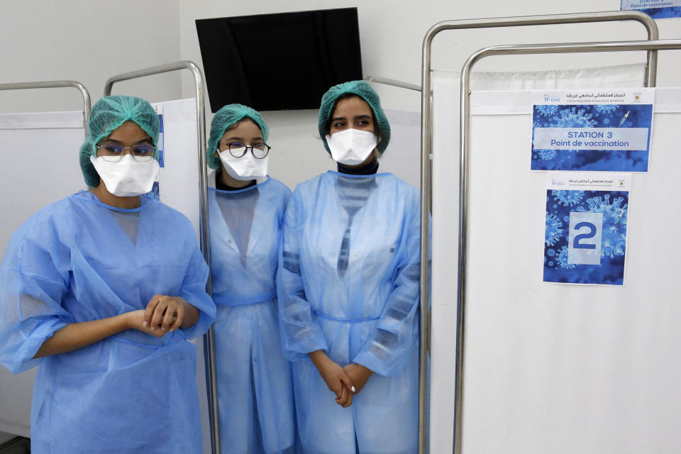 Moroccan nurses wait inside a vaccination booth before administering doses of Sinopharm Covid-19 to a member of the health agency, on the first day of the vaccination campaign, in Casablanca, Morocco, on Friday, Jan. 29, 2021. The King of Morocco Mohammed VI received his vaccine against coronavirus Thursday at the palace Royal Fez launching and officially the vaccination campaign Covid-19 in his country, it will aim at first mainly health workers, security forces and people over 75 years, according to the Moroccan authorities. (AP Photo/Abdeljalil Bounhar)