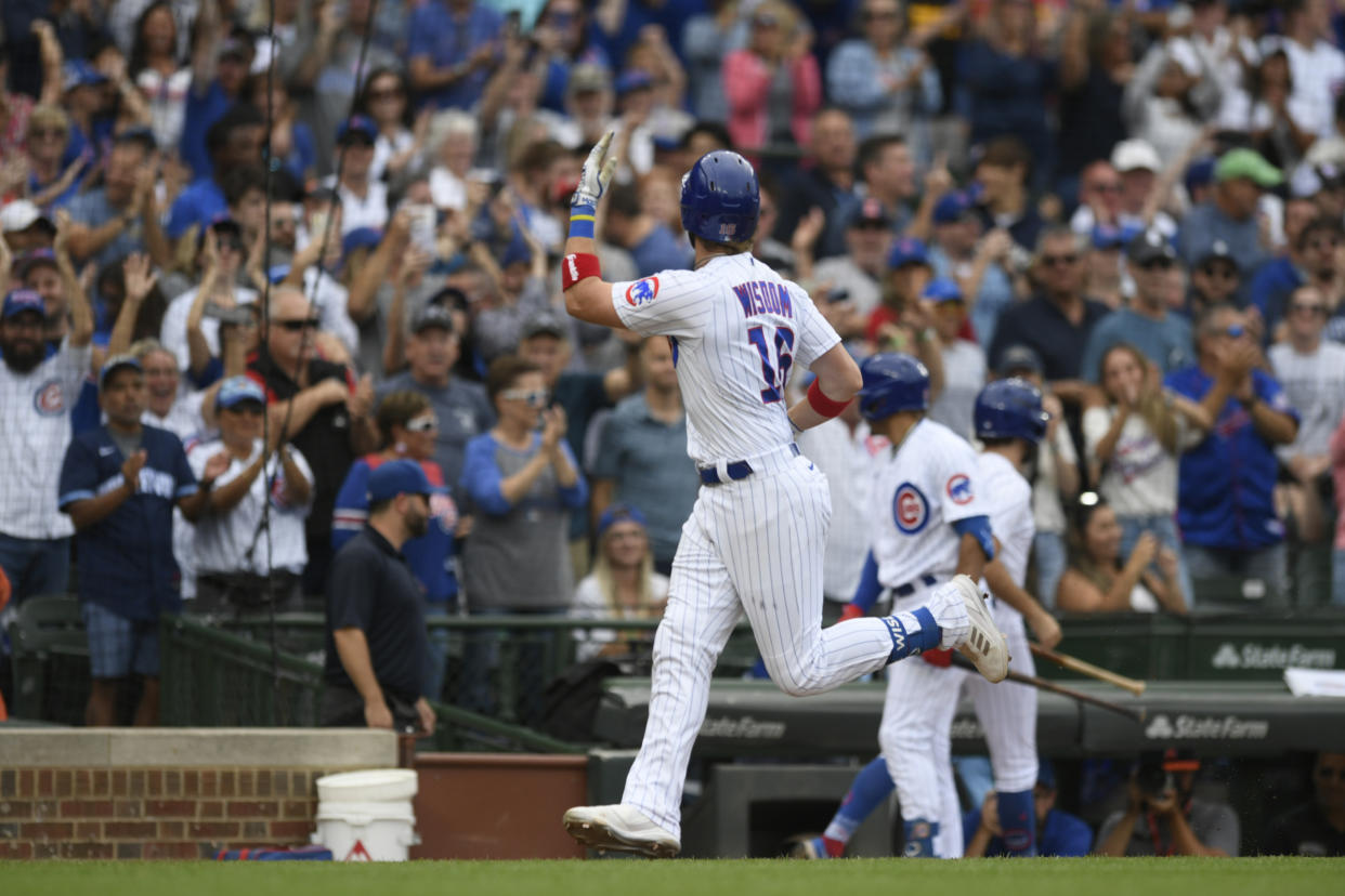 Chicago Cubs' Patrick Wisdom (16) waves to the crowd while rounding the bases after hitting a two-run home run during the sixth inning of a baseball game against the Colorado Rockies Sunday, Sept. 24, 2023, in Chicago. Chicago won 4-3. (AP Photo/Paul Beaty)