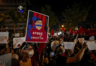 An anti-government protester displays a picture of detained activist Parit Chiwarak during protest outside the Criminal court in Bangkok, Thailand, Saturday, March 6, 2021. A new faction of Thailand's student-led anti-government movement calling itself REDEM, short for Restart Democracy, announced plans to march to Bangkok's Criminal Court Saturday to highlight the plight of several detained leaders of the protest movement. (AP Photo/Sakchai Lalit)