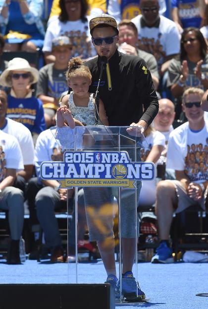 OAKLAND, CA - JUNE 19:  Stephen Curry #30 of the Golden State Warriors holds his daughter Riley Curry while he talks to the fans as they celebrate the Warriors 2015 NBA Championship at The Henry J. Kaiser Convention Center during thier Victory Parade and Rally on June 19, 2015 in Oakland, California.  (Photo by Thearon W. Henderson/Getty Images)