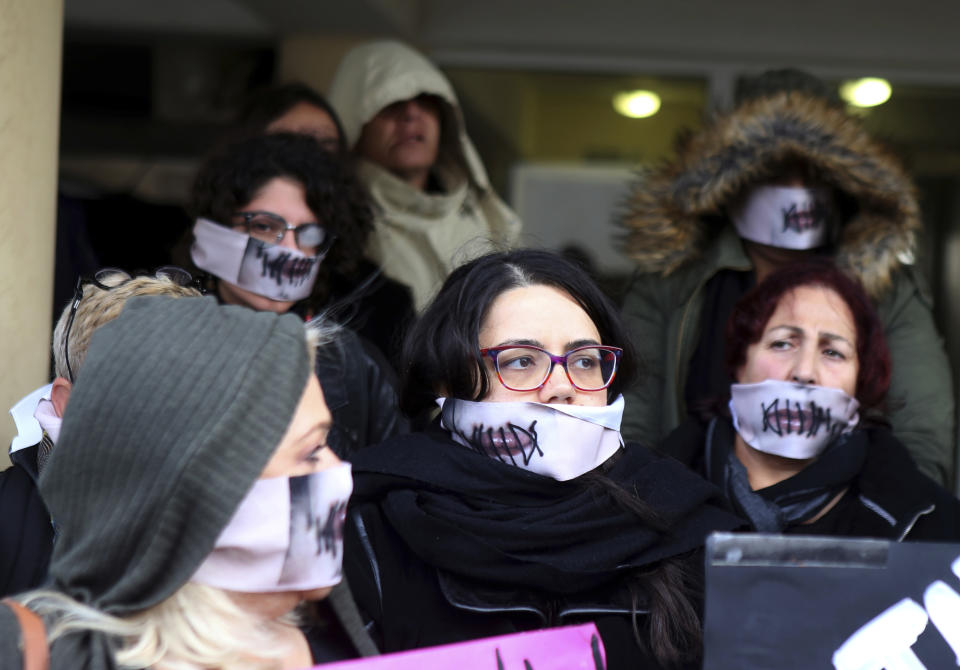 Protesters stage a demonstration outside a court house in Paralimni, Cyprus on Monday, December 30, 2019, in support of a 19 year-old British woman who was found guilty of fabricating claims that she was gang raped by 12 Israelis. Announcing his verdict, Judge Michalis Papathanasiou said the defendant didn't tell the truth and tried to deceive the court with "convenient"and "evasive" statements in court. She is due to be sentenced on Jan. 7. (AP Photo/Philippos Christou)