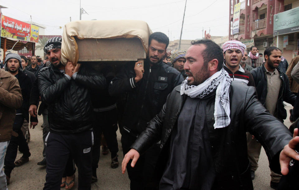 Mourners carry the coffin of a man killed when clashes erupted between al-Qaida gunmen and Iraqi army soldiers on Friday, his family said, during his funeral in Fallujah, 40 miles (65 kilometers) west of Baghdad, Iraq, Saturday, Jan. 4, 2014. Provincial spokesman Dhari al-Rishawi said Iraqi security forces and allied tribesmen are pressing their campaign to rout al-Qaida from Fallujah and Ramadi, two main cities in the western Anbar province. (AP Photo)