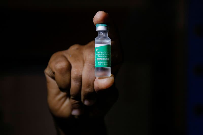 FILE PHOTO: A man displays a vial AstraZeneca's COVISHIELD vaccine as the country receives its first batch of coronavirus disease (COVID-19) vaccines under COVAX scheme, in Accra