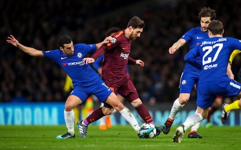 Messi dribbling past Chelsea players - Credit: GETTY IMAGES