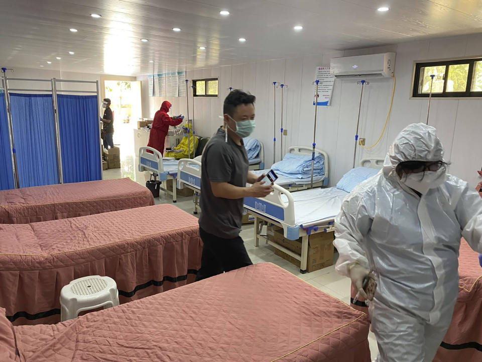 In this May 19, 2020, photo provided by the Philippine National Police, Criminal Investigation and Detection Group (CIDG) Regional Field Units 3, police teams wearing protective suits inspect a seven-bed hospital beside a drug store during a raid at a residential villa, which was illegally turned into a medical facility, at the Clark Freeport and Special Economic Zone northwest of Manila. Philippine police have raided a small clandestine hospital and a drug store catering to Chinese citizens suspected to be infected with the COVID-19 disease and arrested two Chinese administrators. (CIDG Regional Field Units 3 via AP)