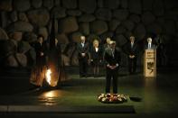 Canada's Prime Minister Stephen Harper (front) pays his respect after laying a wreath during a ceremony in the Hall of Remembrance at the Yad Vashem Holocaust memorial in Jerusalem January 21, 2014. Harper told Israel's parliament on Monday any comparison between the Jewish state and apartheid South Africa was "sickening", drawing a standing ovation - and an angry walkout by two Arab legislators. REUTERS/Baz Ratner (JERUSALEM - Tags: POLITICS)