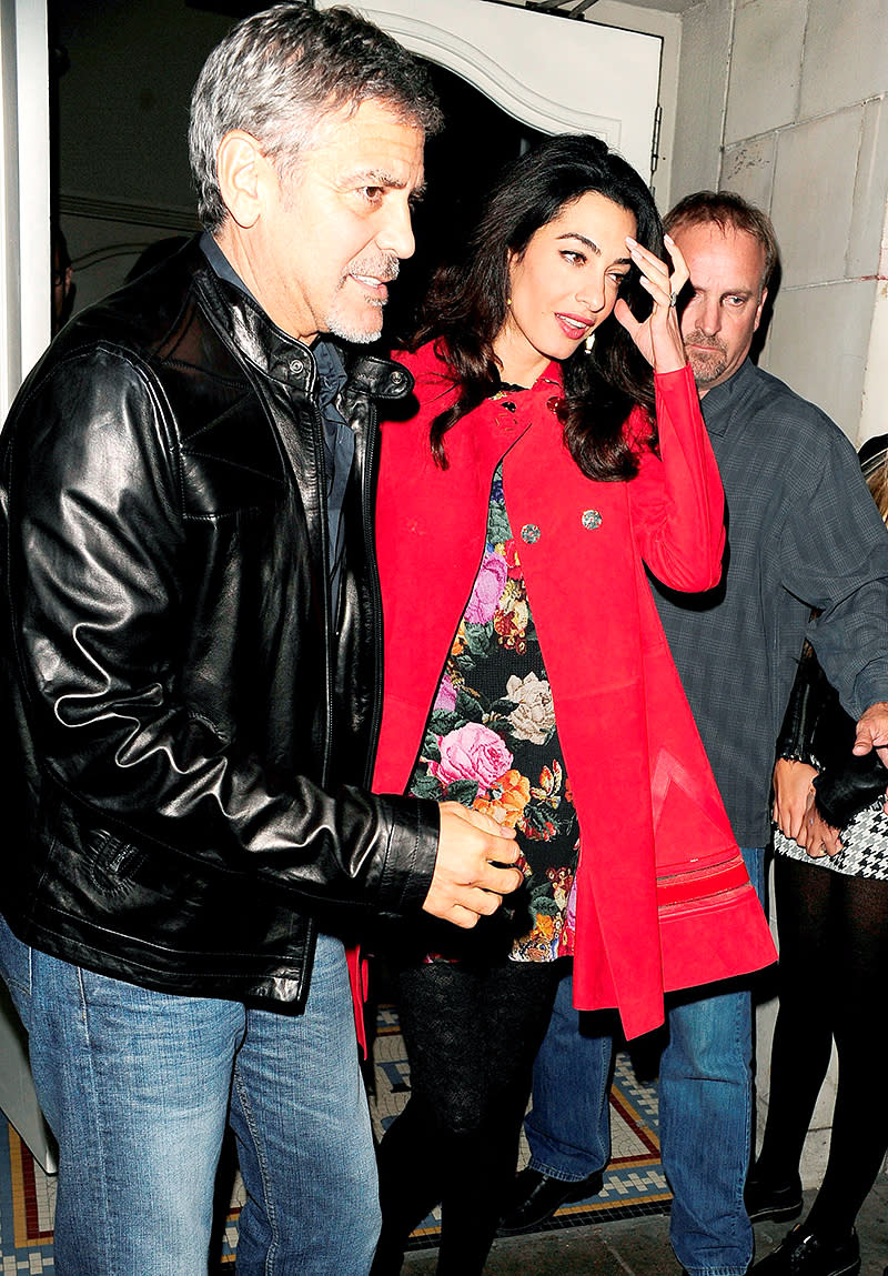 George Clooney and wife Amal try to dodge the cameras on a 2015 date night in London. (Photo: AKM-GSI)
